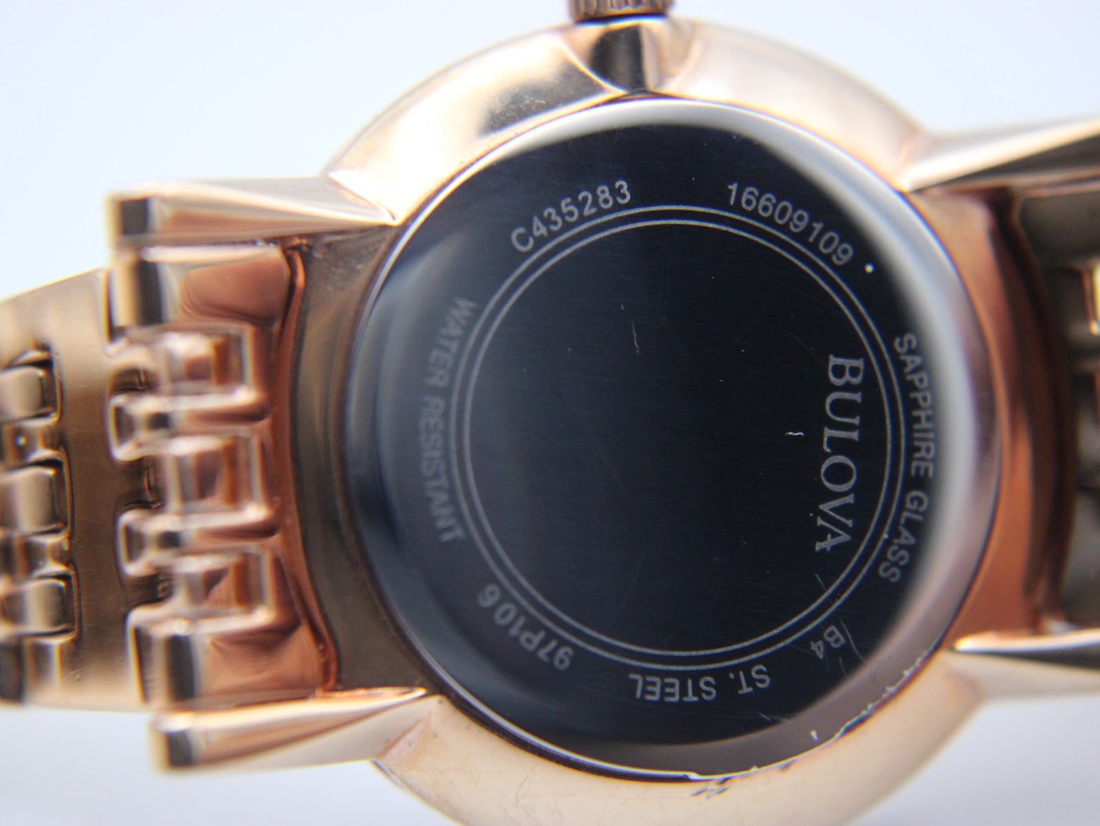 Rear view of the watch case back, showing engravings including 'BULOVA', '97P106', 'SAPPHIRE GLASS', 'ST. STEEL', and 'WATER RESISTANT'.