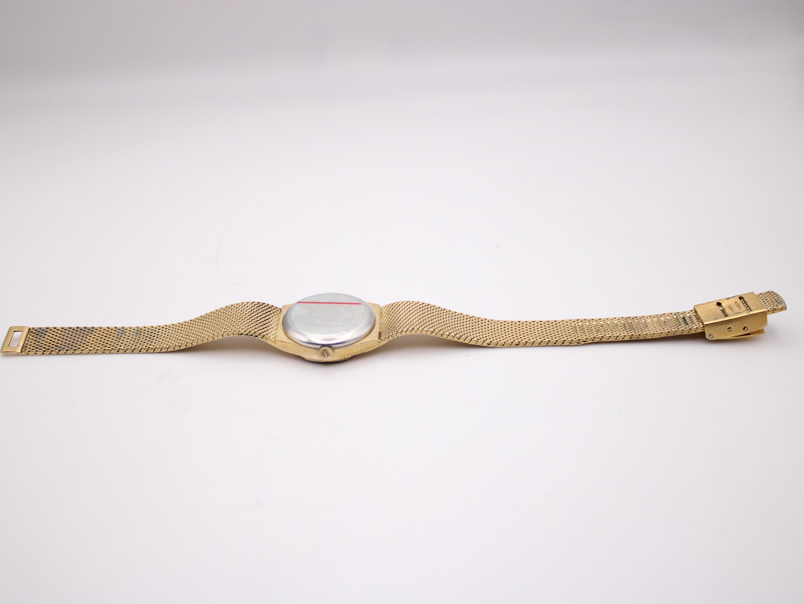 Full length view of the reverse side of the Tissot Stylist watch and integrated bracelet.
