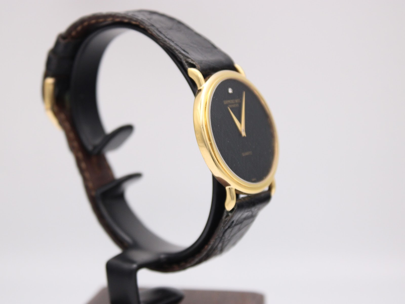 Another angled side view of the Raymond Weil watch, highlighting the profile of the gold case and crown.