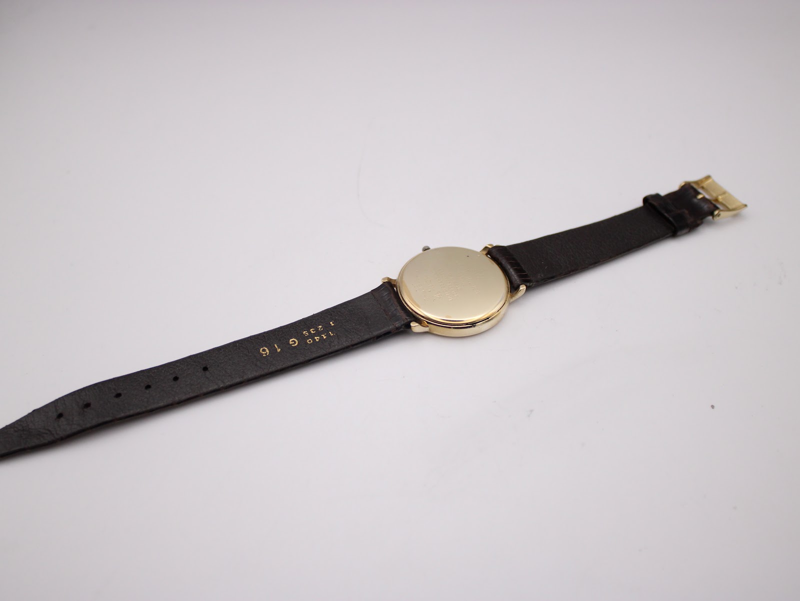 Back view of the Raymond Weil watch and its brown leather strap, showing "G16" marking near the lug, indicating lug width.