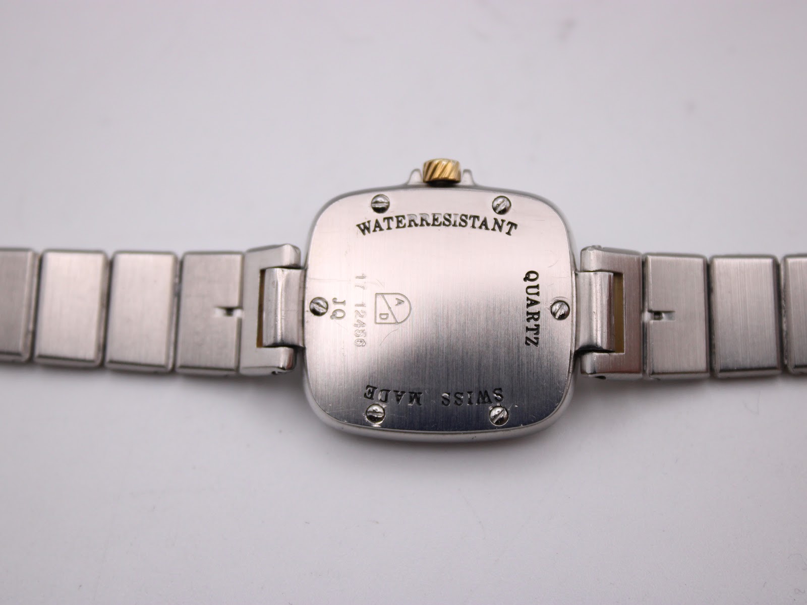 Close-up of the watch case back showing 'Waterresistant', 'Quartz', 'Swiss Made' engravings and reference number.