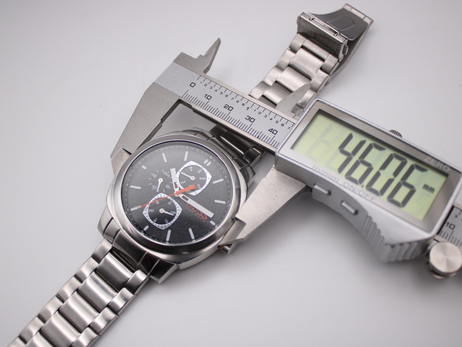 Overhead view of the Hugo Boss Orange watch, with a digital caliper measuring the case diameter at 46.06mm.