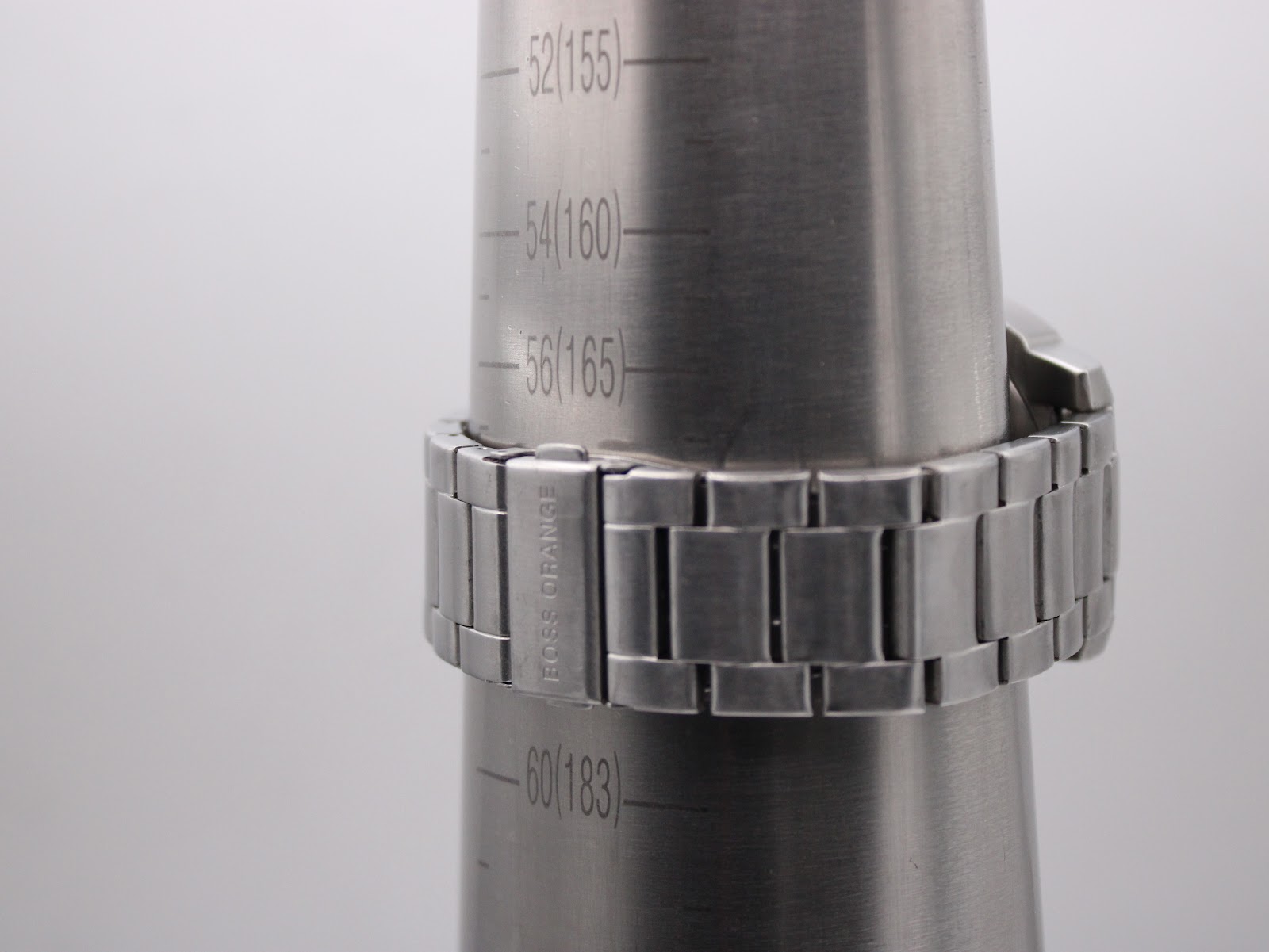Close-up of the Hugo Boss Orange watch bracelet on a wrist sizing gauge, showing the signed "BOSS ORANGE" clasp and indicating a wrist size of approximately 17.5cm.