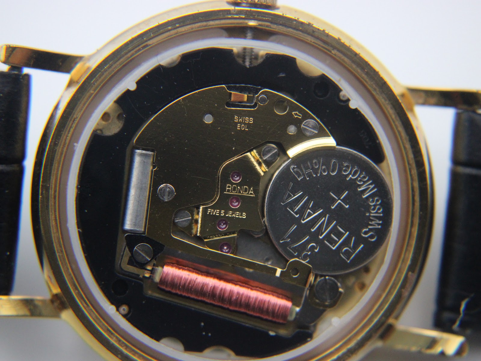 Detailed internal view of the open case back, revealing the Swiss Ronda 5 jewels quartz movement and a Renata battery.
