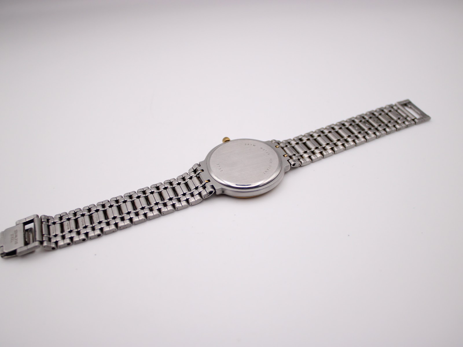 Back view of the Rotary 3705 watch and its bracelet laid flat, detailing the brushed case back and clasp.