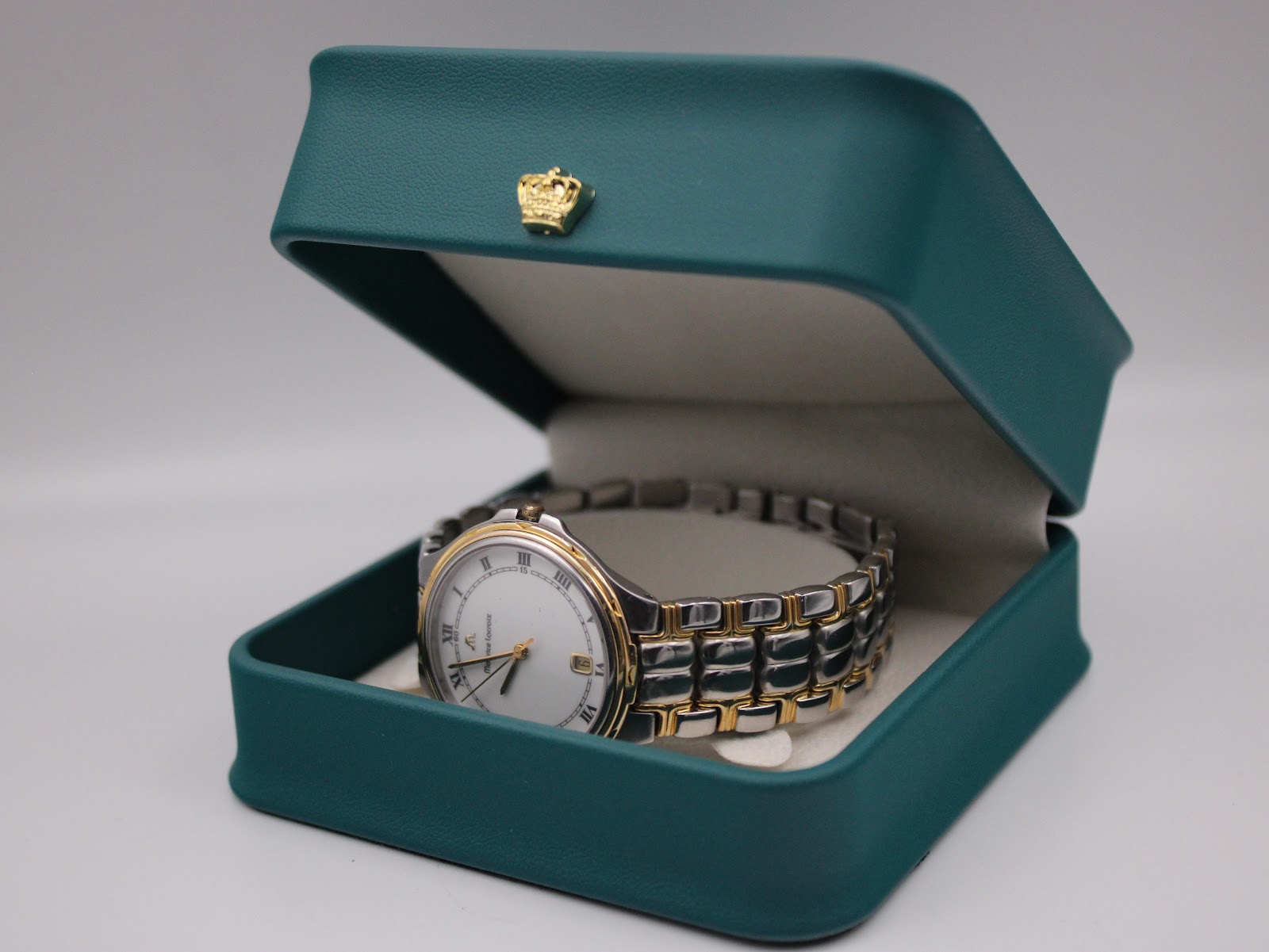 Maurice Lacroix les classiques watch resting in a teal presentation box.