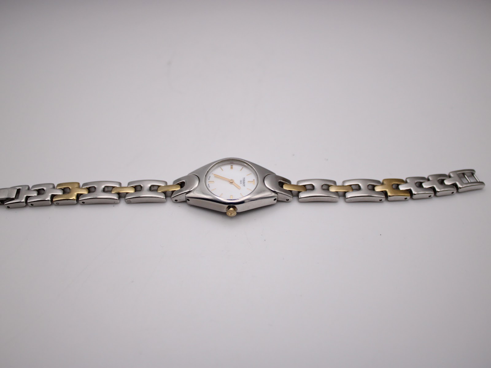 Overhead view of the Tissot T-Trend watch laid flat, displaying the full length of the two-tone stainless steel bracelet.