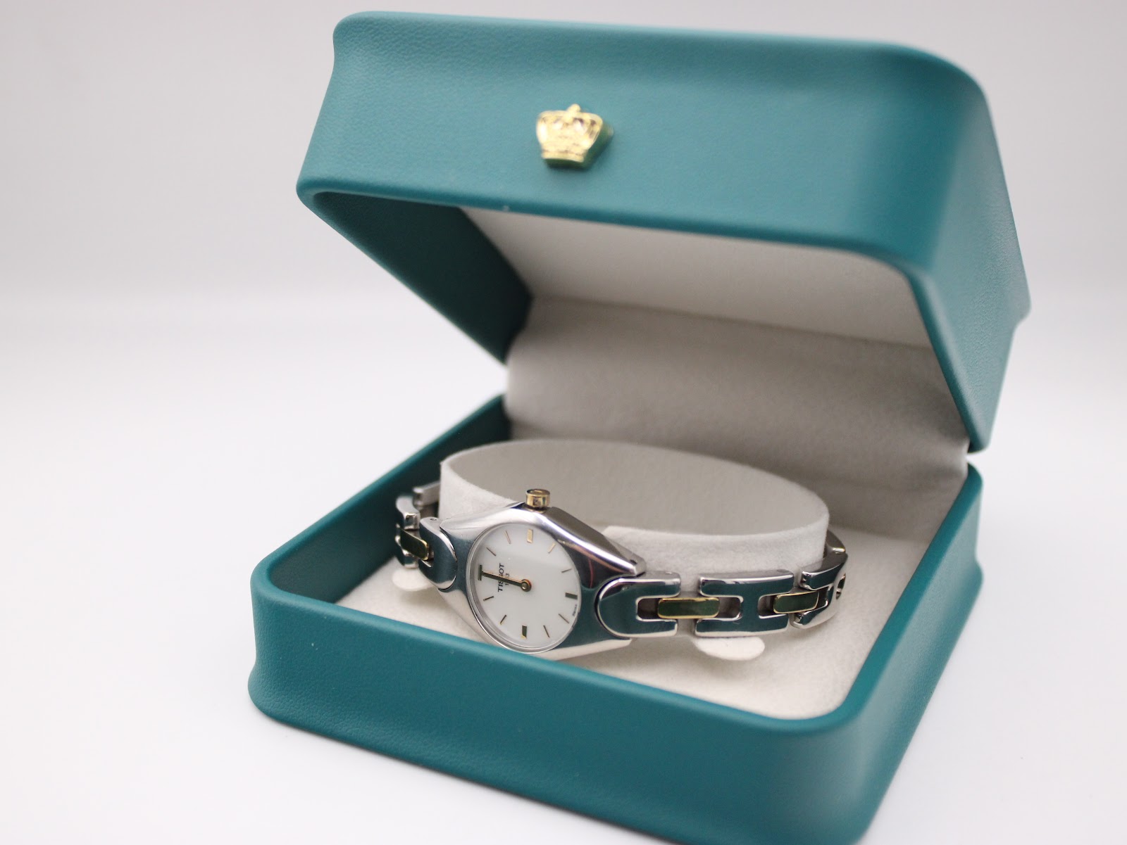 The Tissot T-Trend watch resting inside a teal-coloured non-original presentation box.