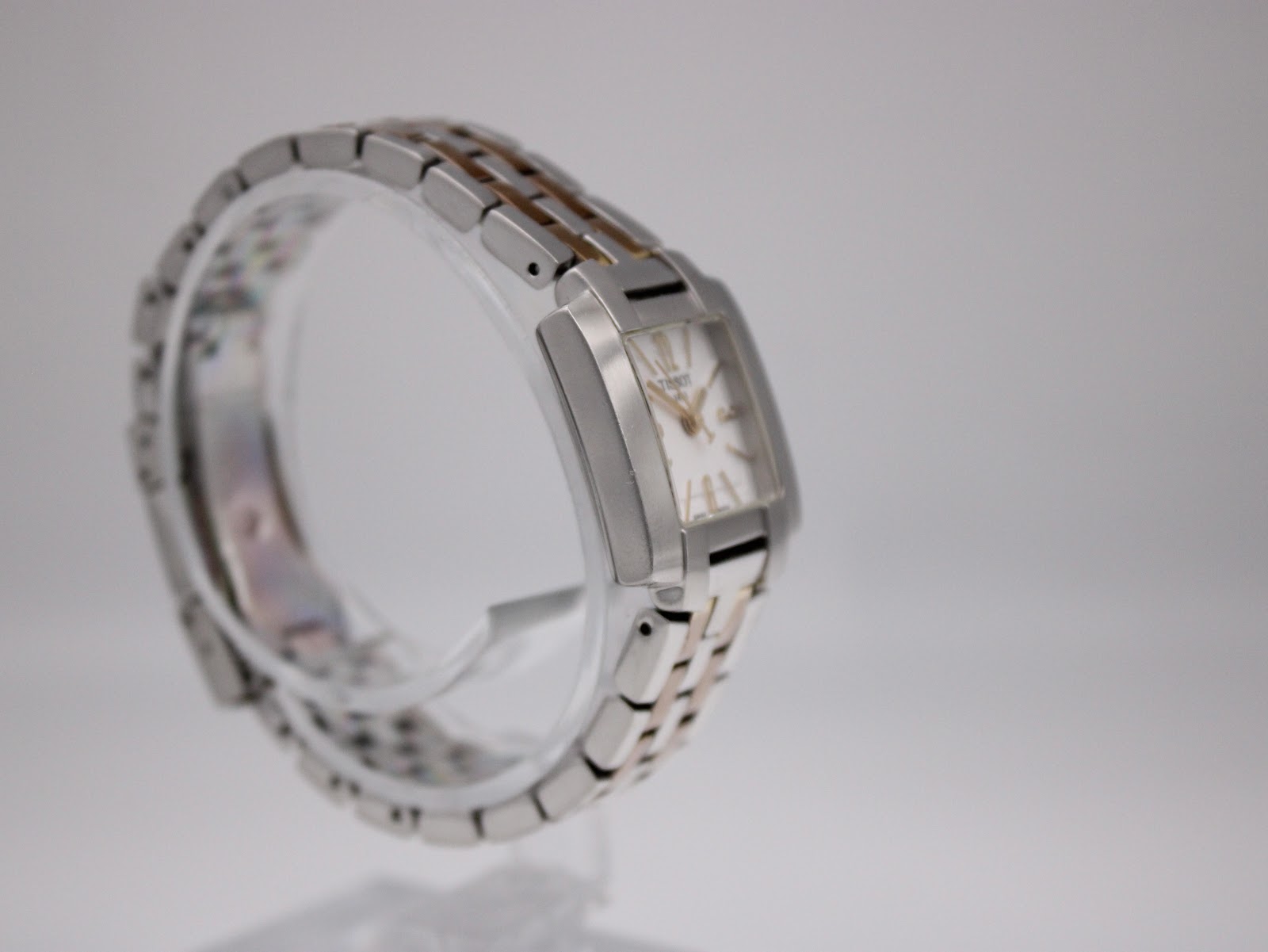 Another angled side view of the Tissot T-Trend watch, showing the bracelet's integrated design and the watch's slim profile.