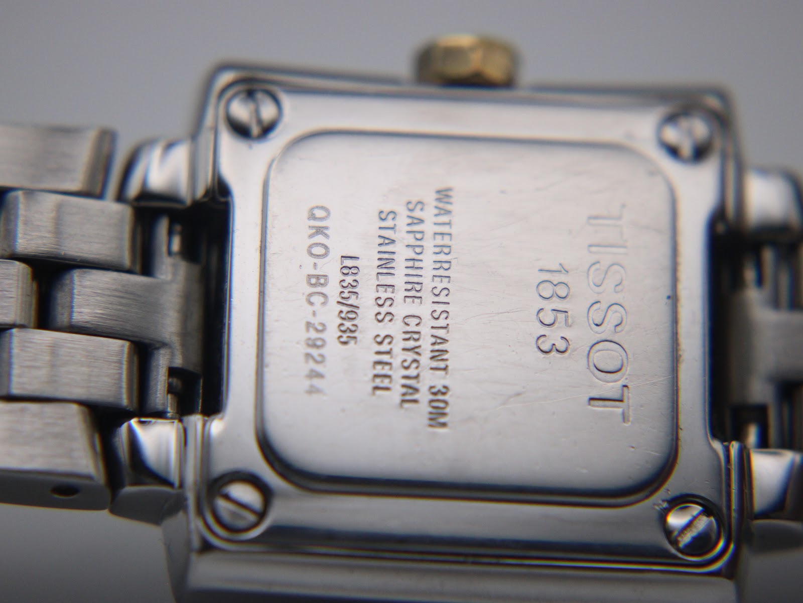 Close-up view of the Tissot T-Trend watch case back, showing engravings for Tissot, 1853, L835/935, Waterresistant 30M, Sapphire Crystal, and Stainless Steel.