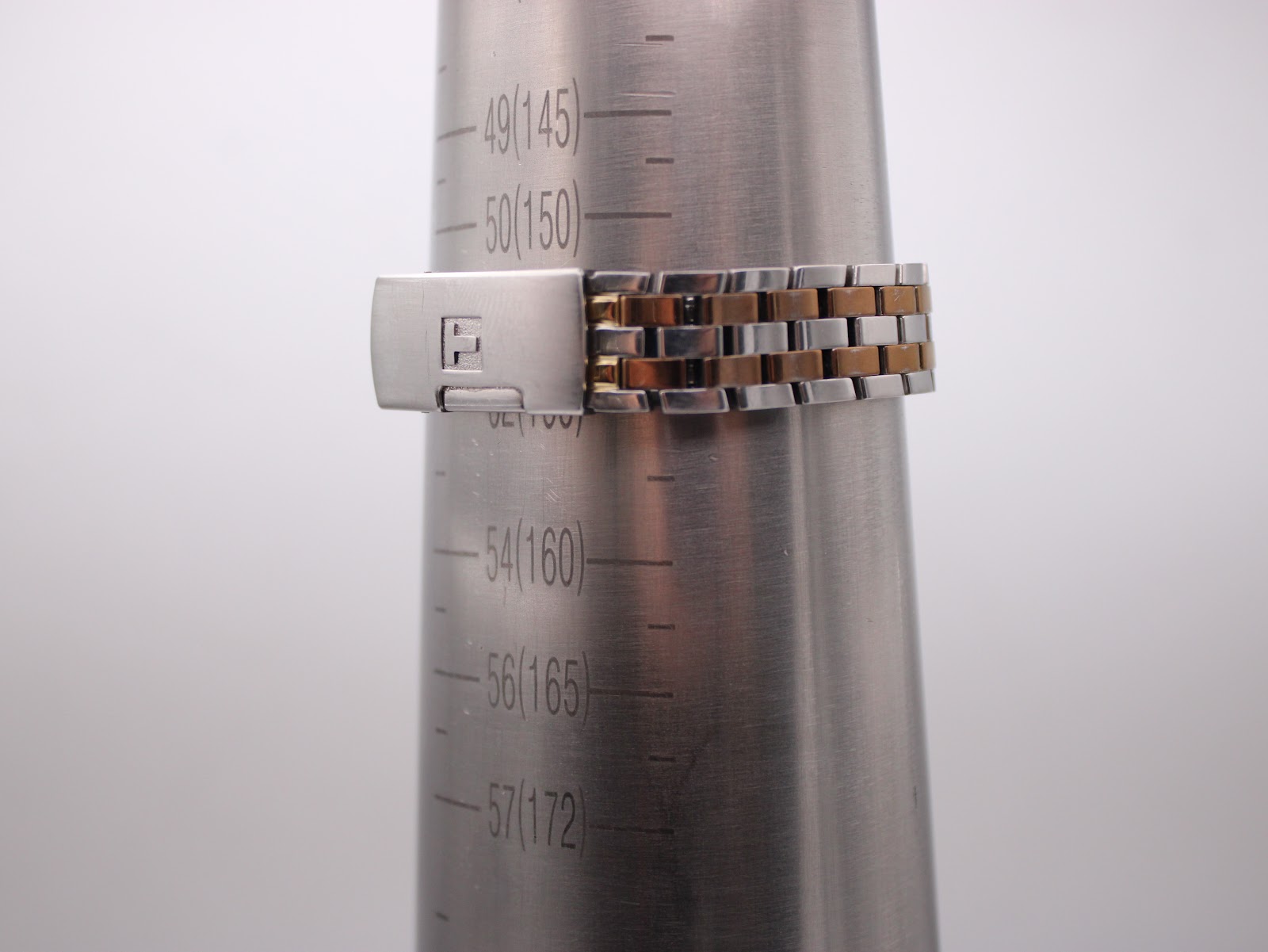 The Tissot T-Trend watch bracelet wrapped around a wrist sizing gauge, indicating a fit of approximately 15.5 cm circumference.