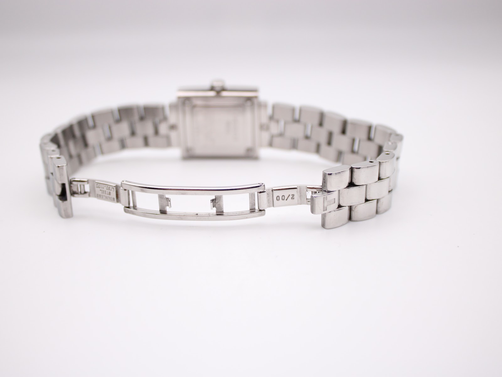 Close-up of the stainless steel butterfly deployant clasp, showing Tissot engraving and "2/00" production code.