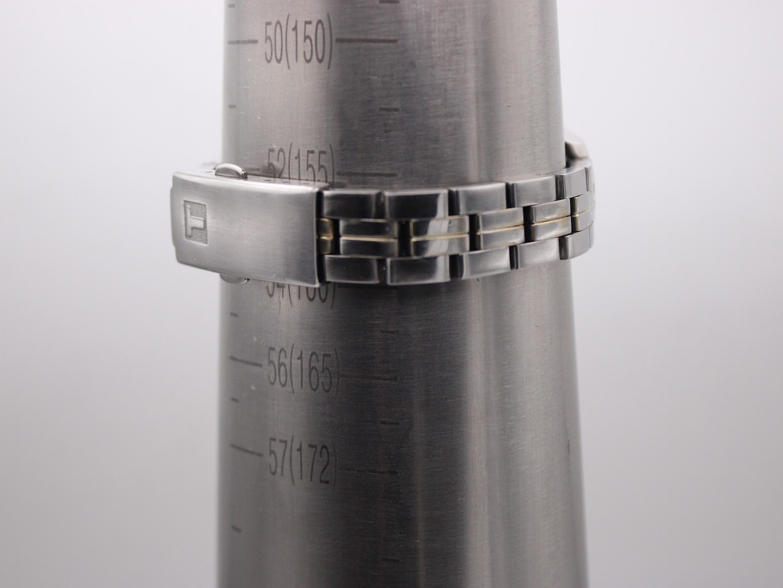 The watch bracelet fitted around a wrist sizing cone, indicating an approximate wrist circumference of 15.5 cm.