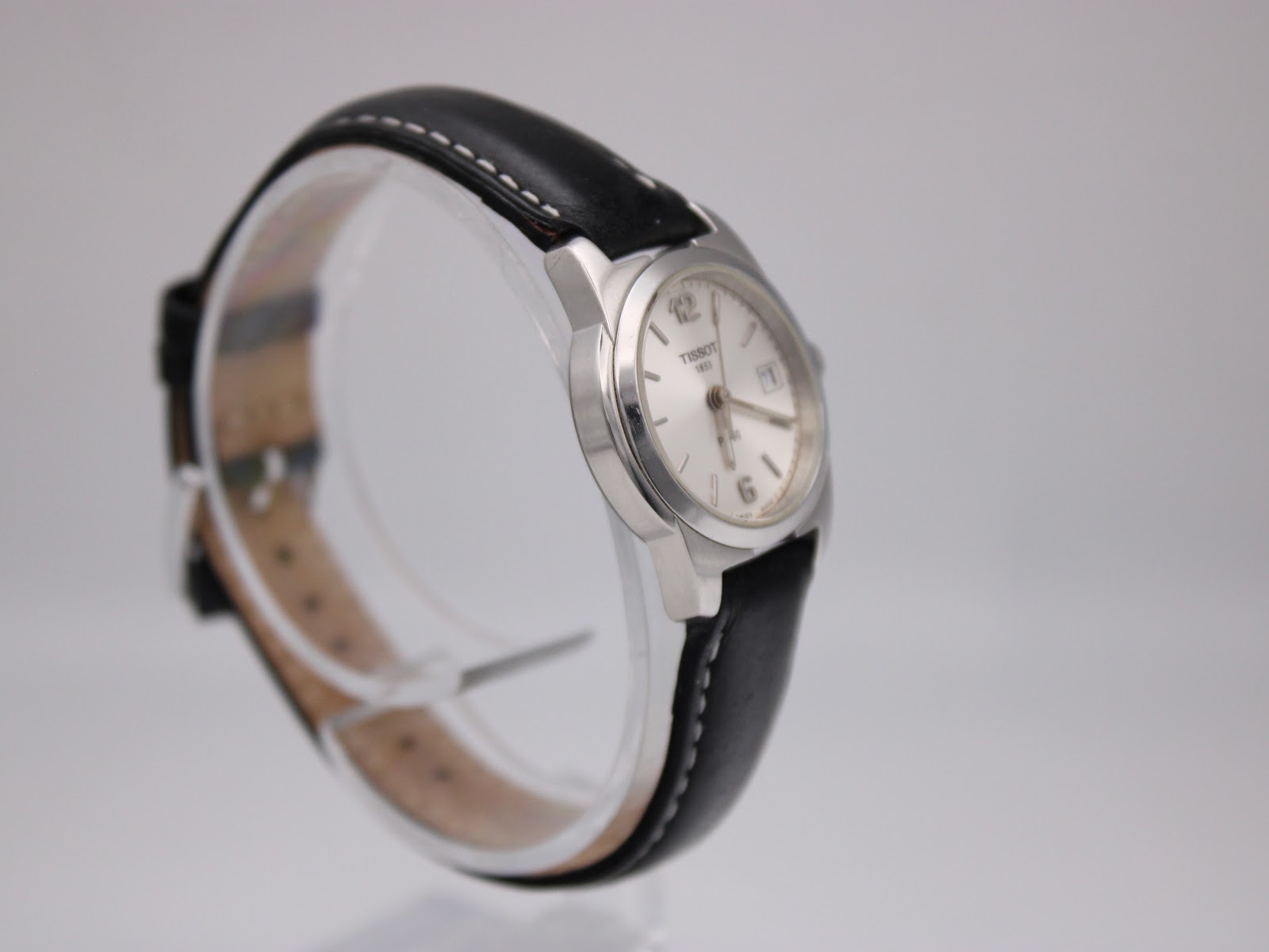 Angled view of the Tissot J326426 watch, highlighting the case profile and the black leather strap.