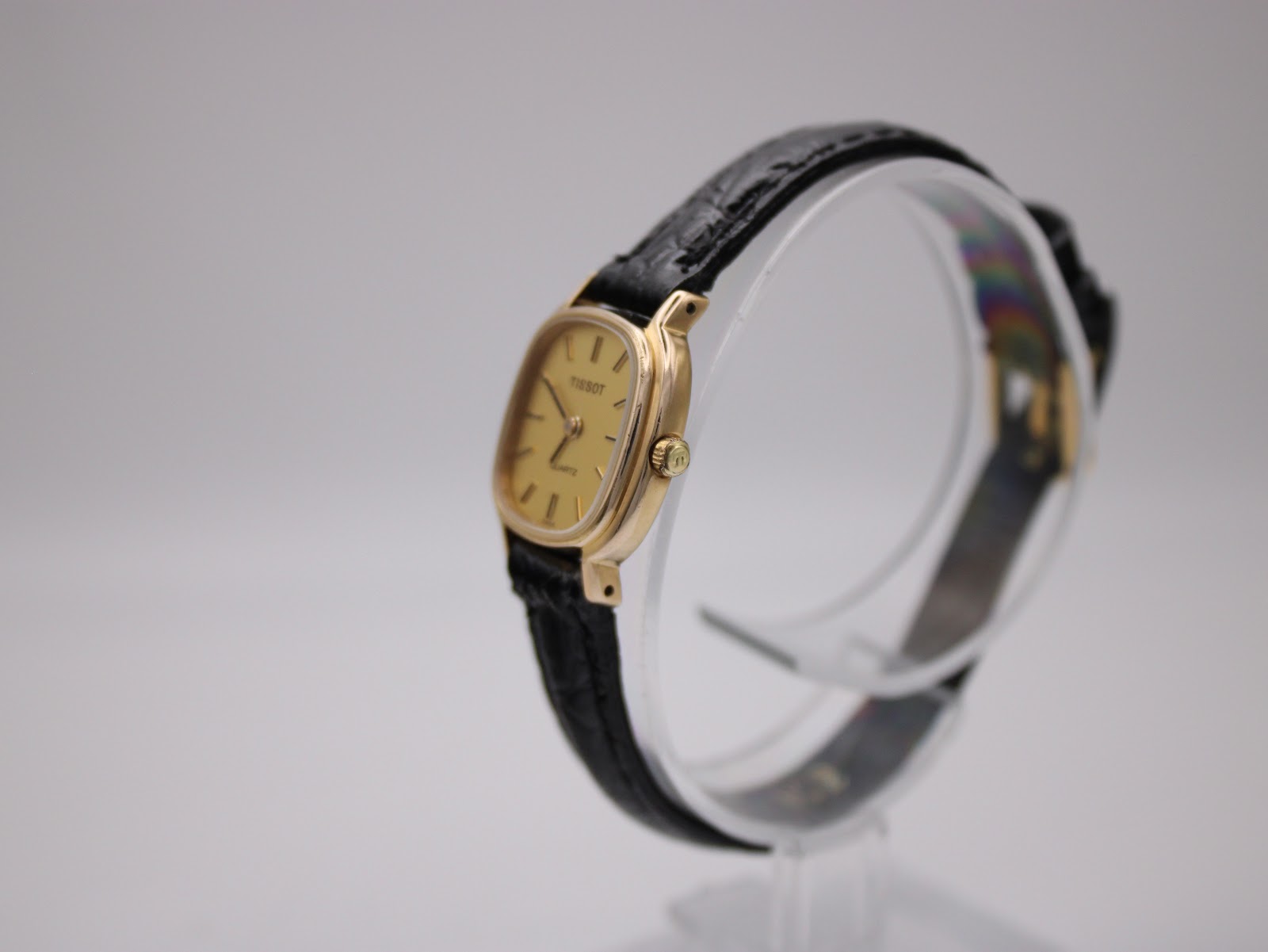 Side profile of Tissot cushion case, showing crown and strap.