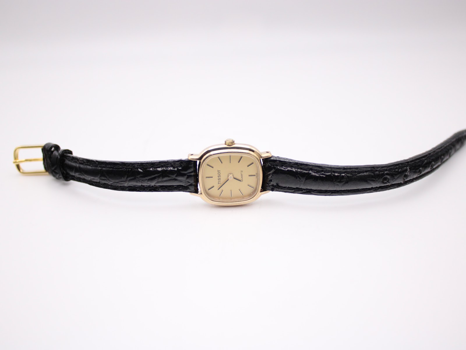 Detail of black croc-effect genuine leather watch strap.