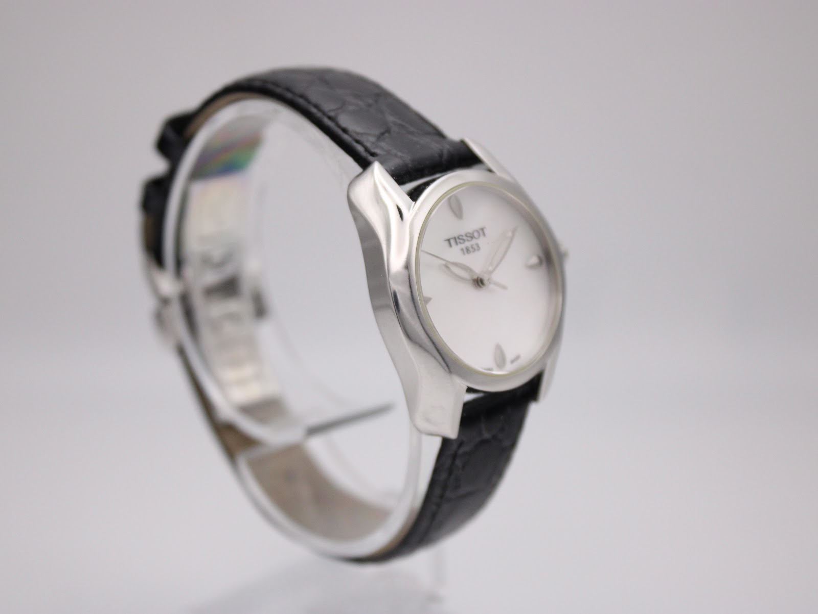 Another angled side view of the Tissot T023210A watch, showcasing the polished stainless steel case and curved lugs.